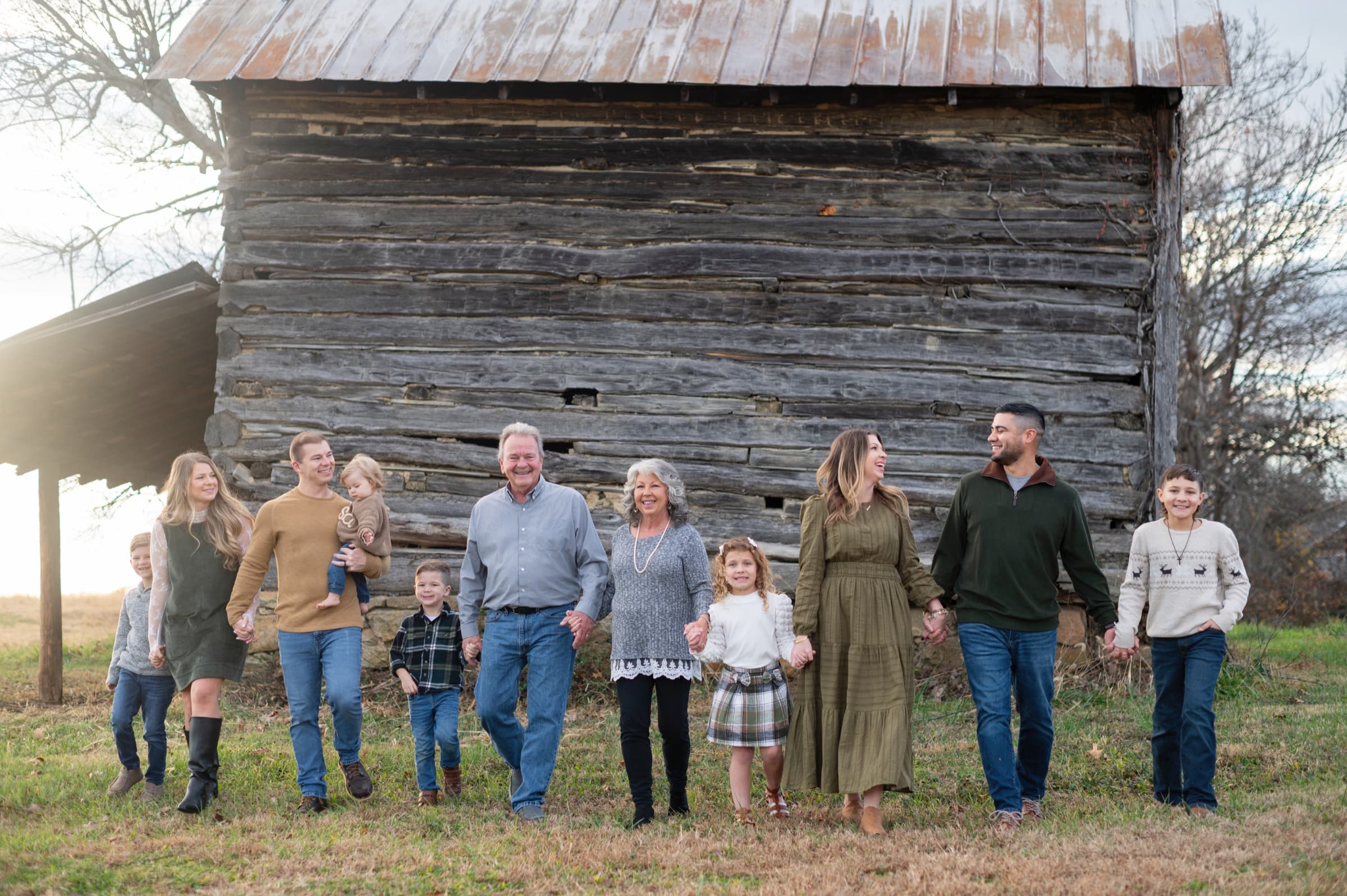 Extended family walking together at a rustic farm