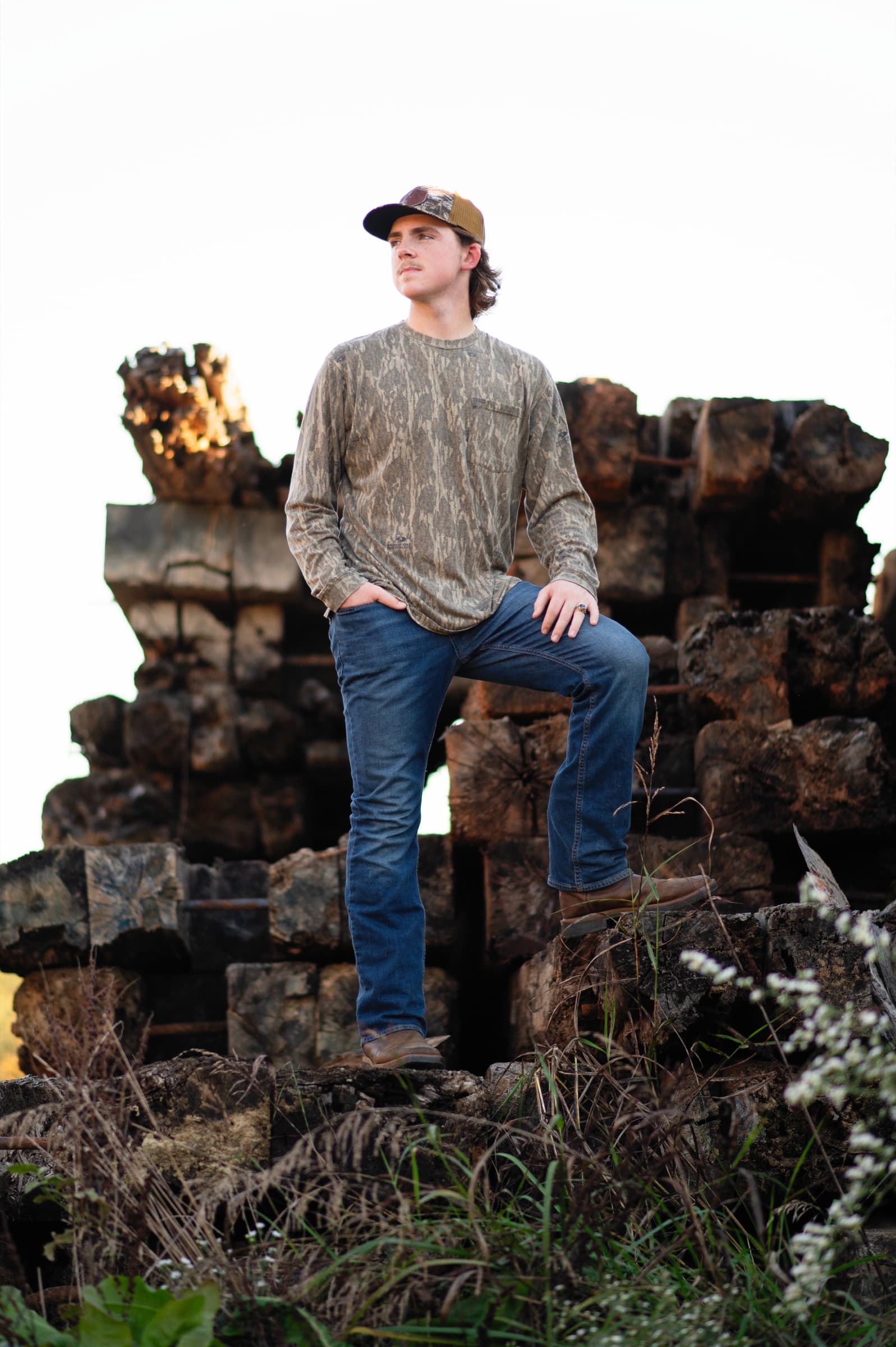 Senior boy portrait at a rustic location