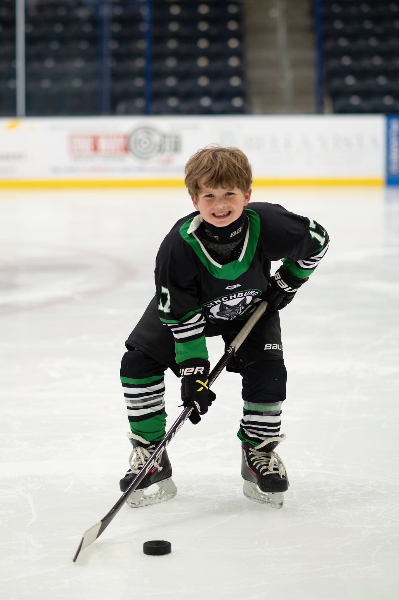 Smiling Coyotes player lining up the puck