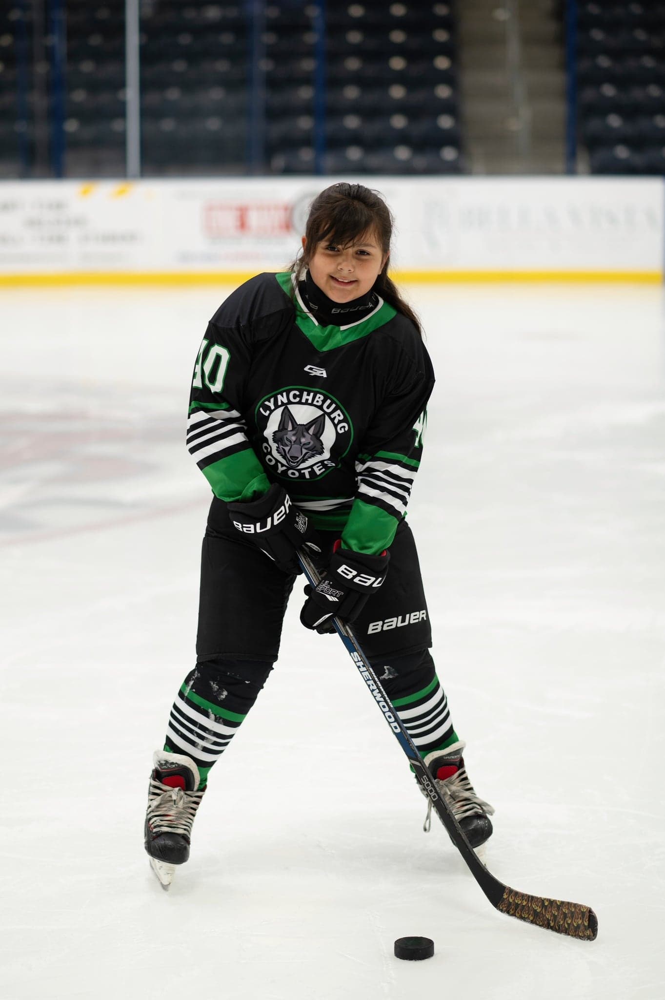 Coyotes player standing tall with stick and puck on the ice