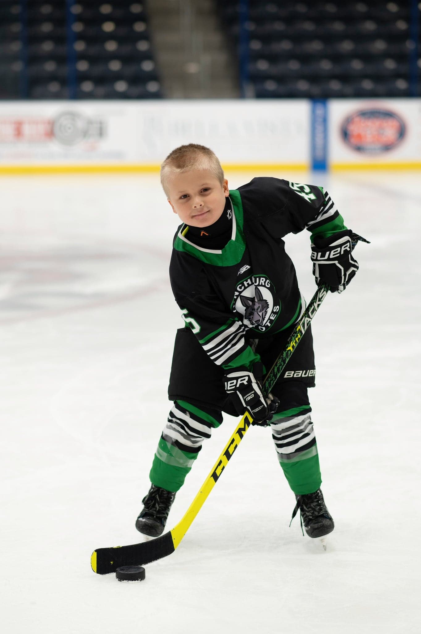 Coyotes player ready to shoot with a yellow stick