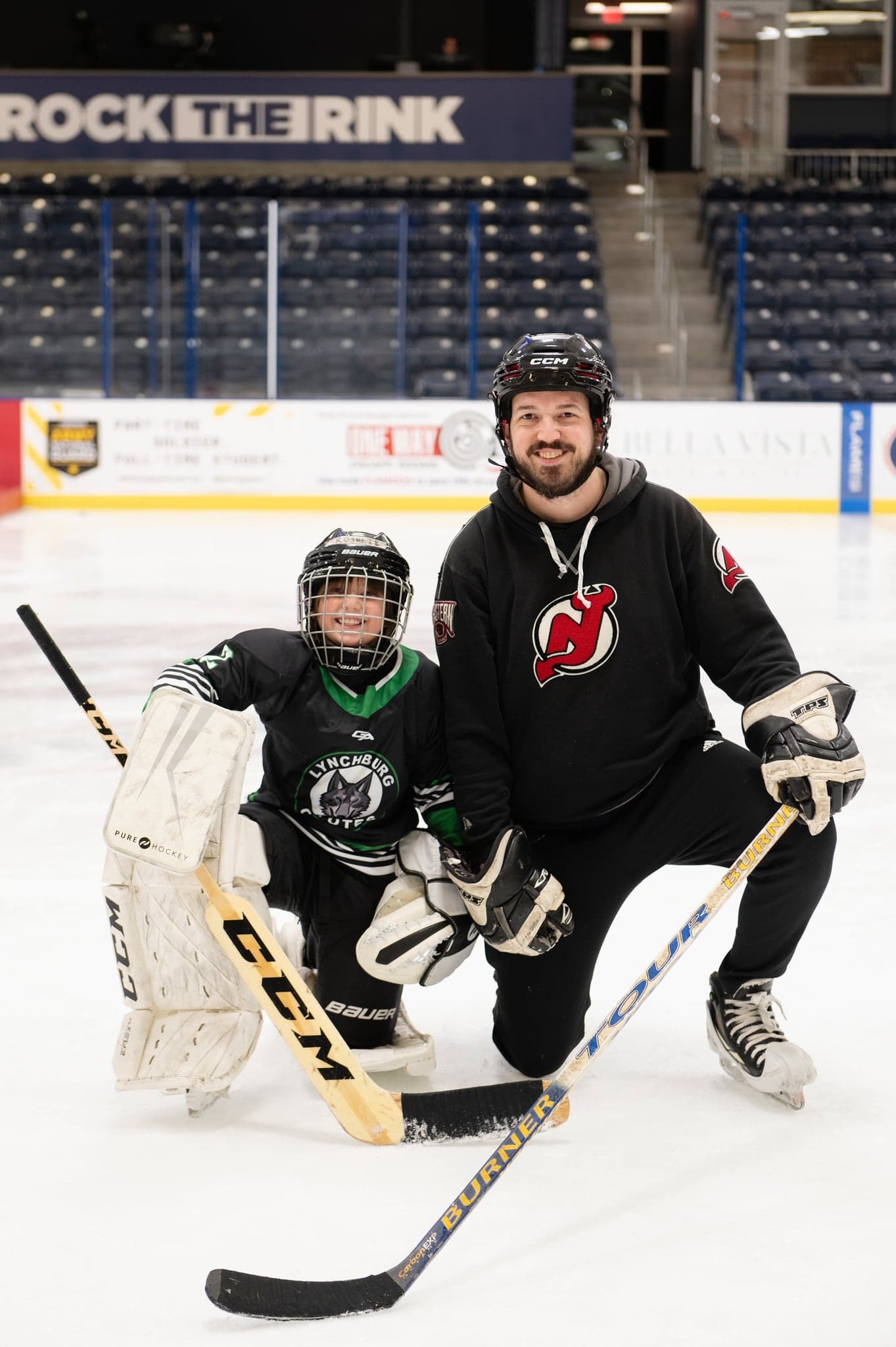Coyotes goalie with a coach on the ice